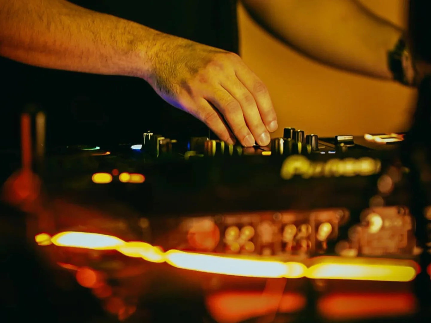 DJ hands on mixer